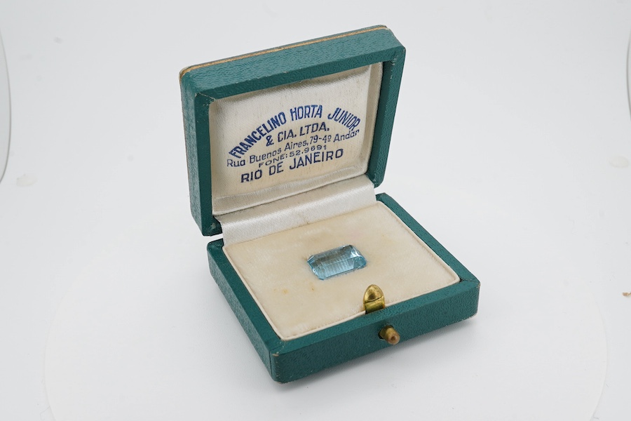 An unmounted emerald cut aquamarine, weighing approximately 6.00ct, in a fitted gilt tooled leather box by Francelino Horta Junior, Rio De Janeiro. Condition - fair to good